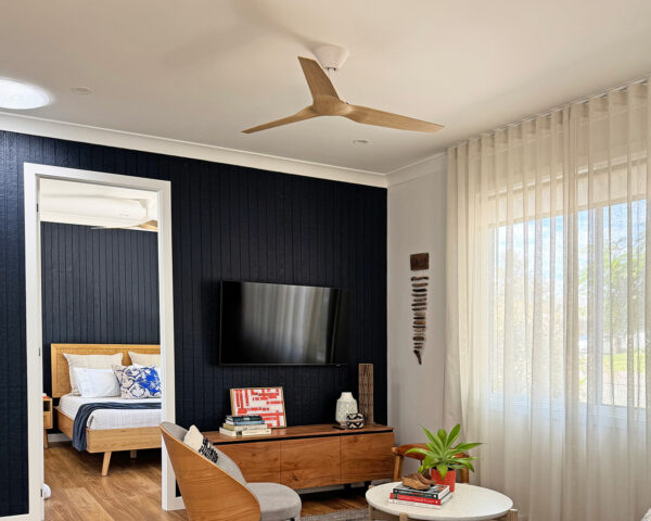 Fanco Infinity-iD ceiling fan in white with beechwood blades in James Treble’s guest house living room, matching fans with interior design.