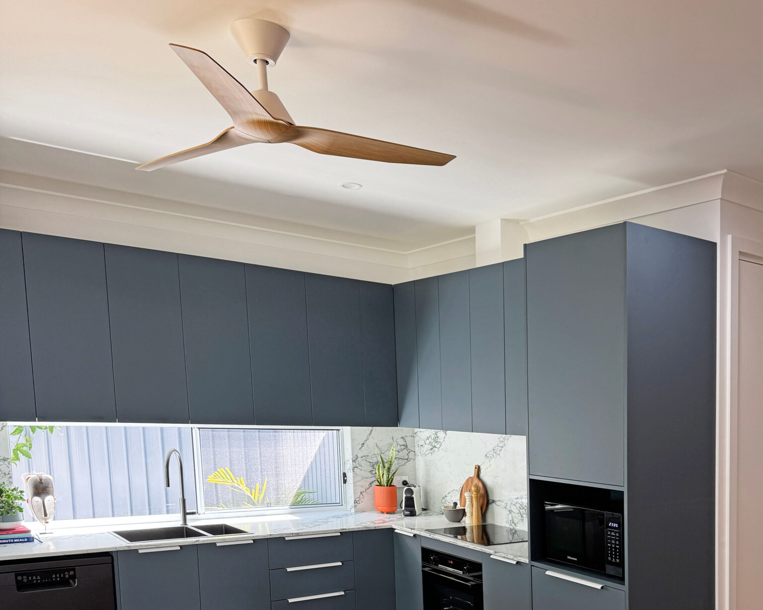 Fanco Infinity-iD DC ceiling fan in white with beechwood blades in James Treble’s guest house kitchen, Australia